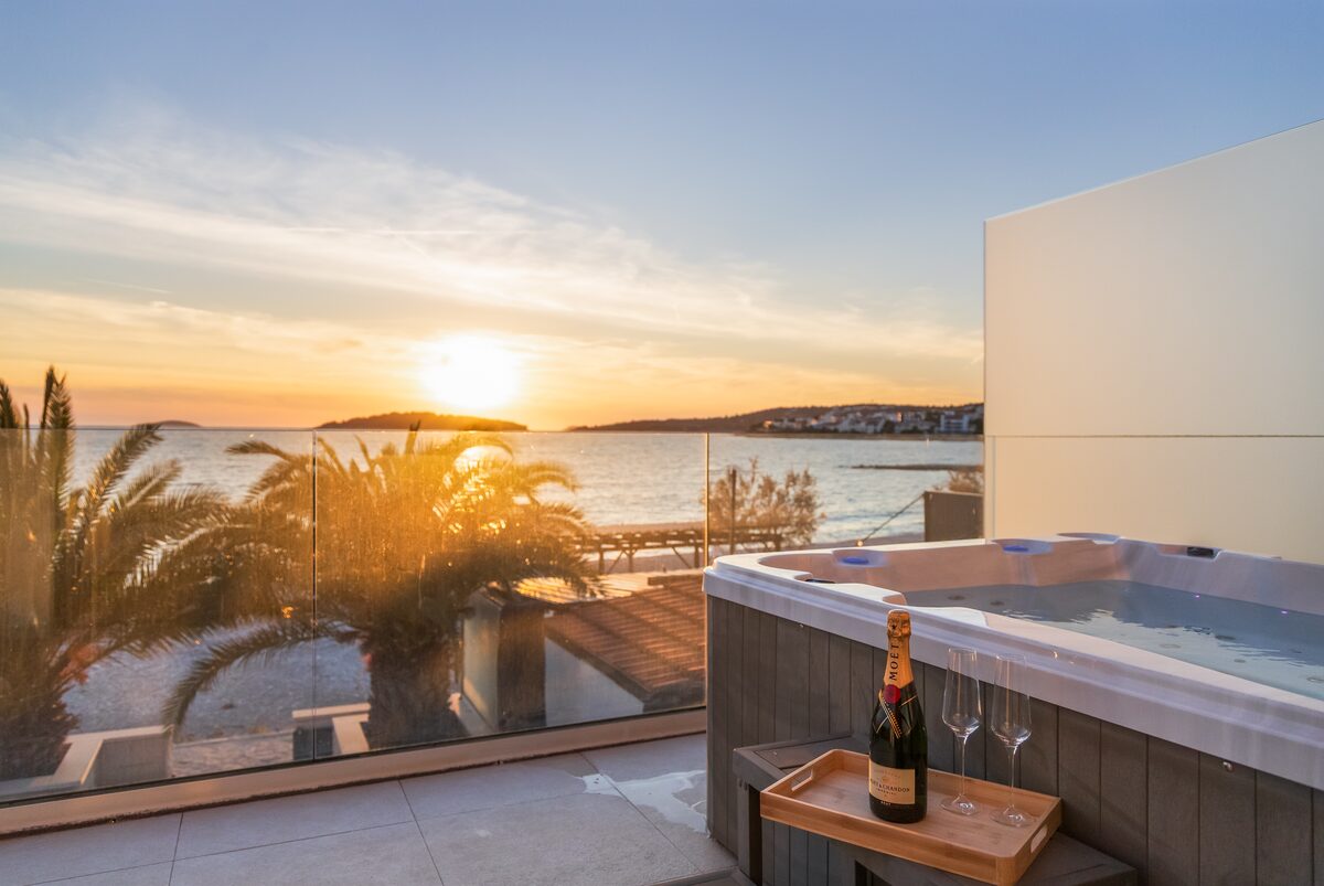 Private heated whirlpool jacuzzi on the terrace at sunset overlooking the Adriatic Sea