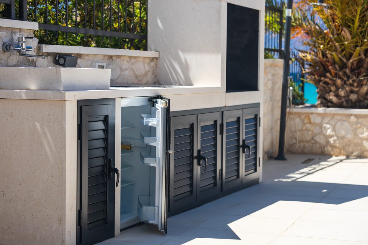 Outdoor kitchen with stone counter and Bosch fridge at The Beachhouse Rogoznica
