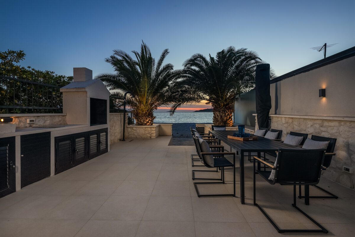 Outdoor dining table set for dinner at night, The Beachhouse Rogoznica