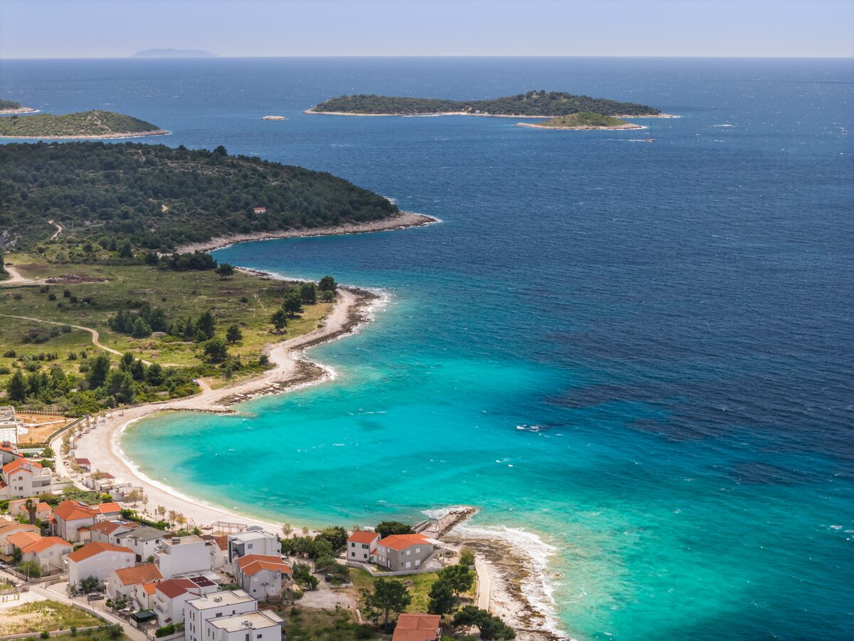 Aerial view of Rogoznica bay and white pebble beach in front of The Beachhouse