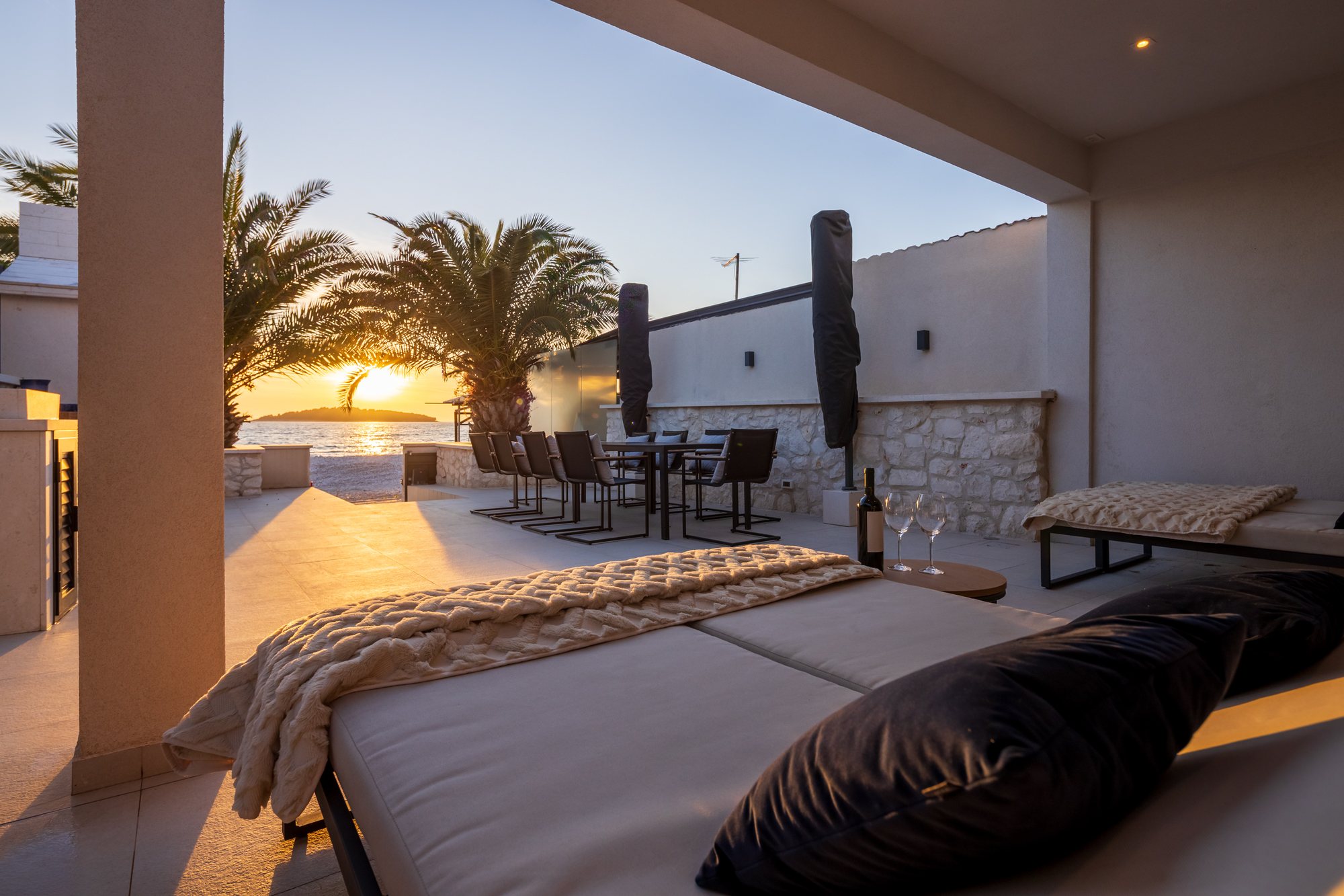 Sunset and evening on the terrace of The Beachhouse Rogoznica luxury villa overlooking the Adriatic
