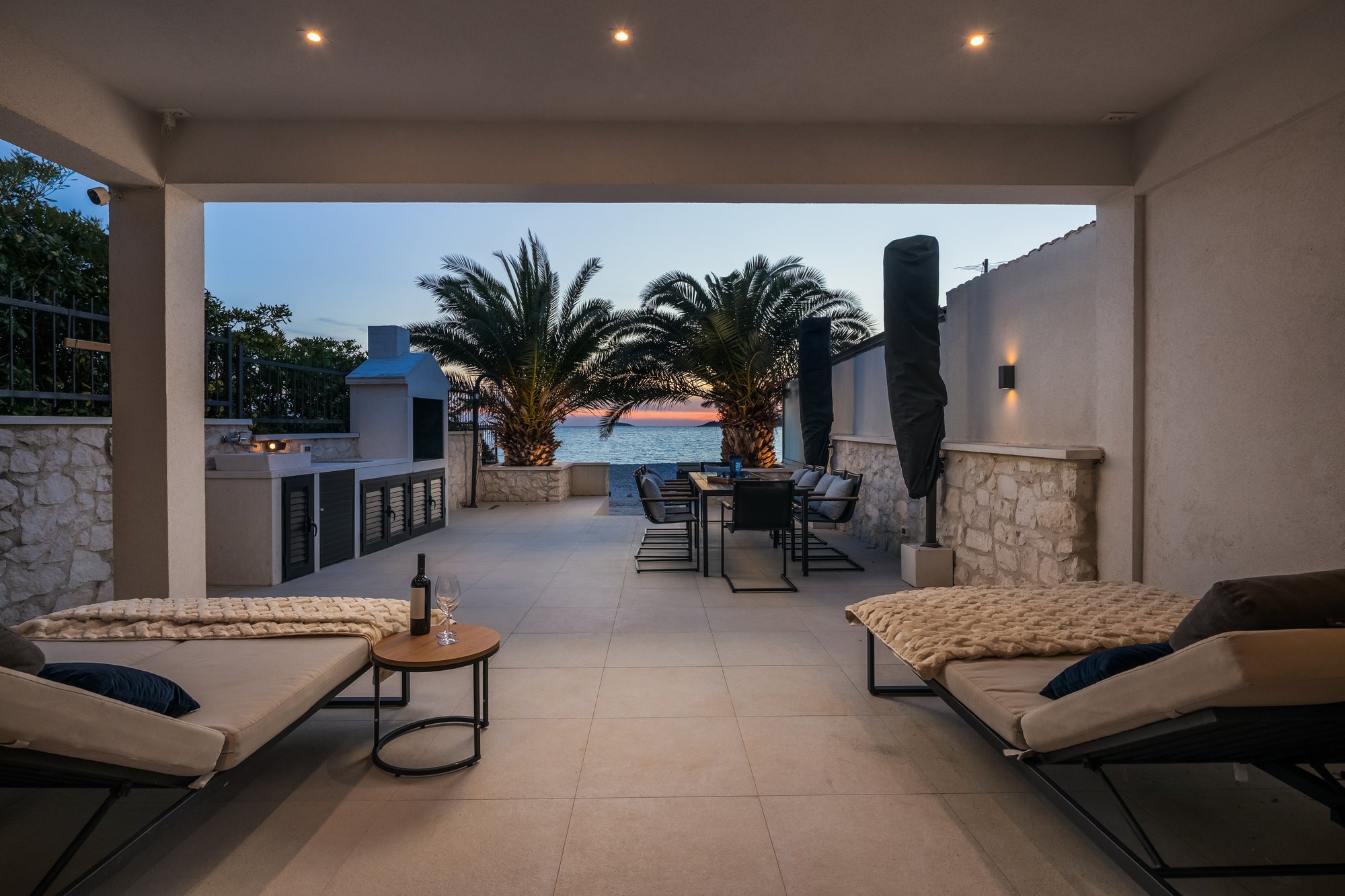 Sunset and evening on the terrace of The Beachhouse Rogoznica luxury villa overlooking the Adriatic