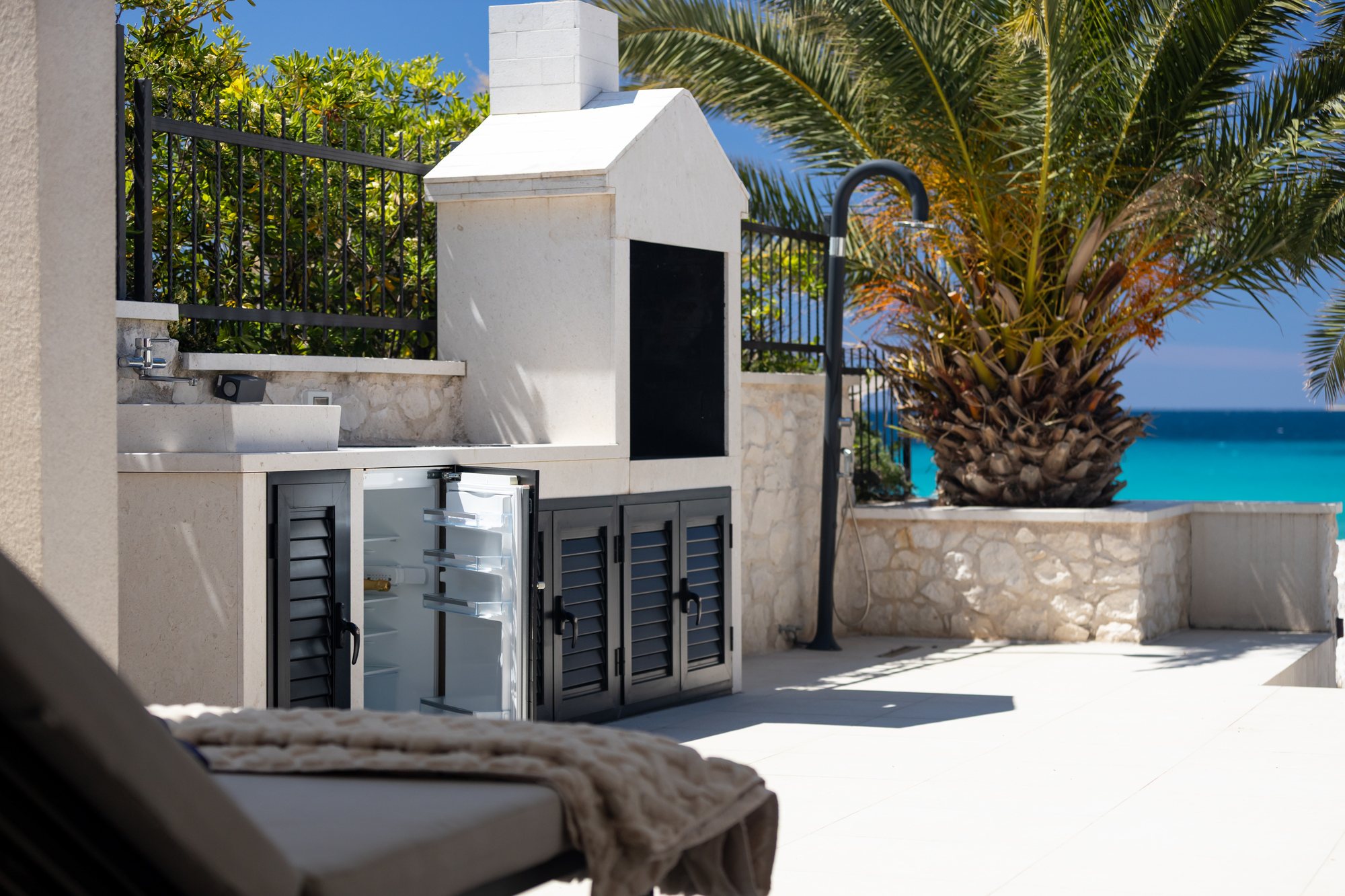 Outdoor kitchen and private heated whirlpool at The Beachhouse Rogoznica luxury beachfront villa Croatia